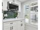 Modern kitchenette featuring ample counter space, stainless steel appliances, and shuttered windows at 14170 Fennsbury Dr, Tampa, FL 33624