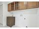 Well-lit laundry room with shaker cabinets and stainless sink at 14170 Fennsbury Dr, Tampa, FL 33624