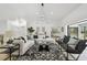 Bright living room featuring modern furniture, stylish decor, and sliding glass doors to the pool area at 14170 Fennsbury Dr, Tampa, FL 33624
