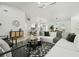 Bright, open living room features a modern light fixture and seamlessly connects to the dining area and kitchen at 14170 Fennsbury Dr, Tampa, FL 33624