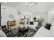 Bright, open living room features a modern light fixture and seamlessly connects to the dining area and kitchen at 14170 Fennsbury Dr, Tampa, FL 33624