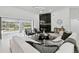 Cozy living room with fireplace, modern décor, and views of the screened in pool at 14170 Fennsbury Dr, Tampa, FL 33624