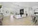 Spacious living room with a fireplace, a sliding glass door with a pool view, and modern lighting at 14170 Fennsbury Dr, Tampa, FL 33624