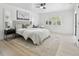 Serene main bedroom features large windows, neutral décor, and a stylish ceiling fan at 14170 Fennsbury Dr, Tampa, FL 33624