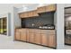 Outdoor kitchen features wooden cabinets, granite countertops, and a built-in grill at 14170 Fennsbury Dr, Tampa, FL 33624