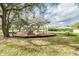 A playground is surrounded by trees, with a picnic table at 14170 Fennsbury Dr, Tampa, FL 33624