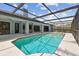 A screened in pool features clean blue water and a large deck at 14170 Fennsbury Dr, Tampa, FL 33624