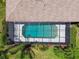 Aerial view of a screened-in pool with clear blue water and landscaping at 14170 Fennsbury Dr, Tampa, FL 33624