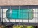 Aerial view of a screened-in pool with clear blue water and cleaning equipment at 14170 Fennsbury Dr, Tampa, FL 33624