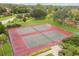 Aerial view of community tennis courts featuring well-maintained courts, surrounded by green space and landscaping at 14170 Fennsbury Dr, Tampa, FL 33624
