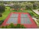 Aerial view of community tennis courts featuring well-maintained courts, surrounded by green space and landscaping at 14170 Fennsbury Dr, Tampa, FL 33624