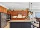 A kitchen area featuring stainless steel appliances, wooden cabinets, and granite countertops at 15936 Ternglade Dr, Lithia, FL 33547