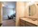 Half bathroom with granite countertop, gray vanity, and brushed nickel faucet at 16170 Colchester Palms Dr, Tampa, FL 33647
