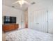 A bedroom with a dresser and a window with white plantation shutters at 16170 Colchester Palms Dr, Tampa, FL 33647