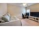 Neutral toned bedroom features a bed, gaming equipment, and a ceiling fan at 16170 Colchester Palms Dr, Tampa, FL 33647