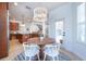 Bright breakfast nook with a modern chandelier, table, seating for four and lots of light at 16170 Colchester Palms Dr, Tampa, FL 33647