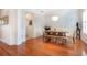 Charming dining room featuring a wooden table and chairs, a patterned wallpaper, and wood flooring at 16170 Colchester Palms Dr, Tampa, FL 33647