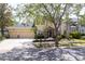 Inviting home with a three-car garage, manicured landscaping, and a charming stone archway above the entryway at 16170 Colchester Palms Dr, Tampa, FL 33647
