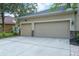 Spacious three-car garage featuring stone accents, providing ample parking and storage space at 16170 Colchester Palms Dr, Tampa, FL 33647