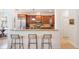 An open concept kitchen with stainless appliances, granite countertops and bar seating at 16170 Colchester Palms Dr, Tampa, FL 33647