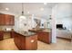 Spacious kitchen with dark cabinets, granite countertops, and a central island, perfect for cooking and entertaining at 16170 Colchester Palms Dr, Tampa, FL 33647