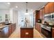 Open kitchen featuring dark wood cabinets, granite countertops, and a center island for functionality at 16170 Colchester Palms Dr, Tampa, FL 33647
