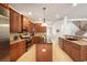 Open kitchen featuring stainless steel appliances, dark wood cabinets, and a center island for meal preparation at 16170 Colchester Palms Dr, Tampa, FL 33647