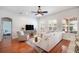 Bright living room with hardwood floors, a comfortable sofa, and large windows for ample natural light at 16170 Colchester Palms Dr, Tampa, FL 33647