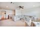 Relaxing living room features a large sectional sofa, ceiling fan, and neutral tones at 16170 Colchester Palms Dr, Tampa, FL 33647