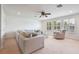Bright living room with a large sectional sofa and big windows with plantation shutters at 16170 Colchester Palms Dr, Tampa, FL 33647