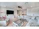 Cozy living room features a large sectional sofa, ceiling fan, and large TV at 16170 Colchester Palms Dr, Tampa, FL 33647