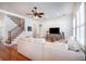 Spacious living room featuring a staircase, a plush sofa, and neutral decor for comfortable living at 16170 Colchester Palms Dr, Tampa, FL 33647
