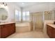 A main bathroom with walk in shower, tub, double sink vanity, and lots of light at 16170 Colchester Palms Dr, Tampa, FL 33647
