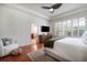 A bedroom with a ceiling fan, hardwood floors, shutters and an ensuite bathroom at 16170 Colchester Palms Dr, Tampa, FL 33647