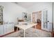 Bright office space featuring white built-ins, a desk, a stylish rug, and a view into the dining room at 16170 Colchester Palms Dr, Tampa, FL 33647