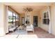 Comfortable screened-in patio with seating, ceiling fan, string lights, and stylish decor for outdoor enjoyment at 16170 Colchester Palms Dr, Tampa, FL 33647