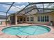 Backyard pool and outdoor entertaining area with screened-in patio, perfect for relaxing at 16170 Colchester Palms Dr, Tampa, FL 33647