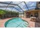 Backyard pool and outdoor entertaining area with screened-in patio, great for hosting gatherings at 16170 Colchester Palms Dr, Tampa, FL 33647