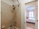 Bathroom shower stall, overhead faucet, tile walls and view into a bedroom at 16170 Colchester Palms Dr, Tampa, FL 33647