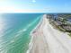 Breathtaking aerial view of the expansive coastline, with clear turquoise waters meeting the sandy beach at 17920 Gulf Blvd # 208, Redington Shores, FL 33708