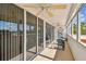 Cozy balcony with table and chairs, perfect for enjoying the views through sliding glass doors at 17920 Gulf Blvd # 208, Redington Shores, FL 33708