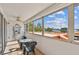 View from the balcony overlooking tropical trees and the ocean at 17920 Gulf Blvd # 208, Redington Shores, FL 33708