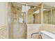 A well-lit tiled bathroom with a glass shower and accessibility features for added convenience at 17920 Gulf Blvd # 208, Redington Shores, FL 33708