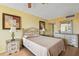 Bedroom featuring neutral walls, laminate flooring, and a large dresser with mirror, and artwork at 17920 Gulf Blvd # 208, Redington Shores, FL 33708