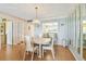 Bright dining area featuring a light fixture and a view into the kitchen at 17920 Gulf Blvd # 208, Redington Shores, FL 33708