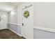 Condo door with welcoming floral wreath in hallway at 17920 Gulf Blvd # 208, Redington Shores, FL 33708