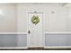 Condo door with welcoming floral wreath at 17920 Gulf Blvd # 208, Redington Shores, FL 33708