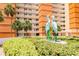 Exterior view of the building's vibrant facade, showcasing tropical landscaping at 17920 Gulf Blvd # 208, Redington Shores, FL 33708