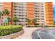 Building's exterior view highlighting its architecture, landscaping, and a circular driveway at 17920 Gulf Blvd # 208, Redington Shores, FL 33708