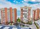 Condominium complex featuring manicured landscaping, parking, and beach access at 17920 Gulf Blvd # 208, Redington Shores, FL 33708